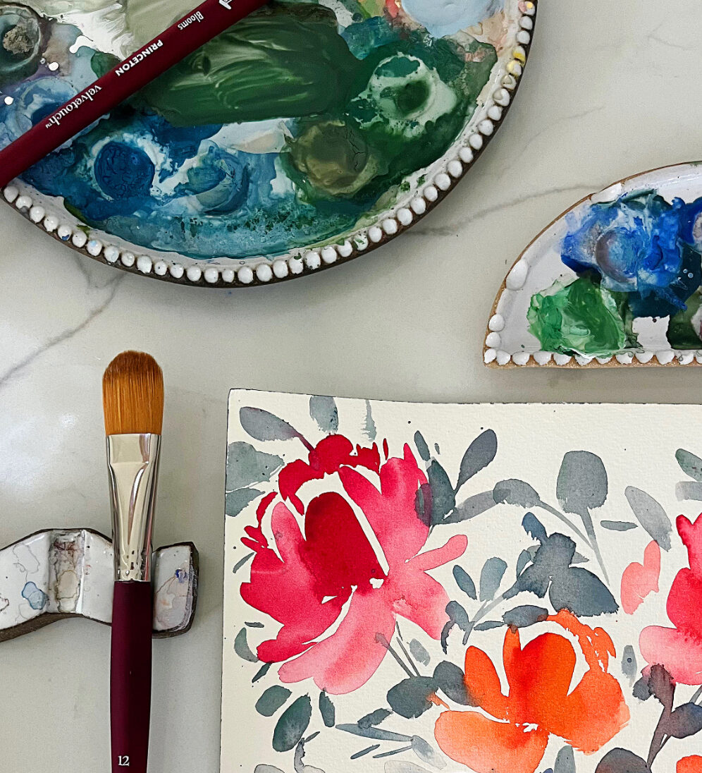 Close-up of bold red and pink floral watercolor with flat brush, demonstrating wet-on-wet and wet-on-dry methods from a watercolor techniques cheat sheet.