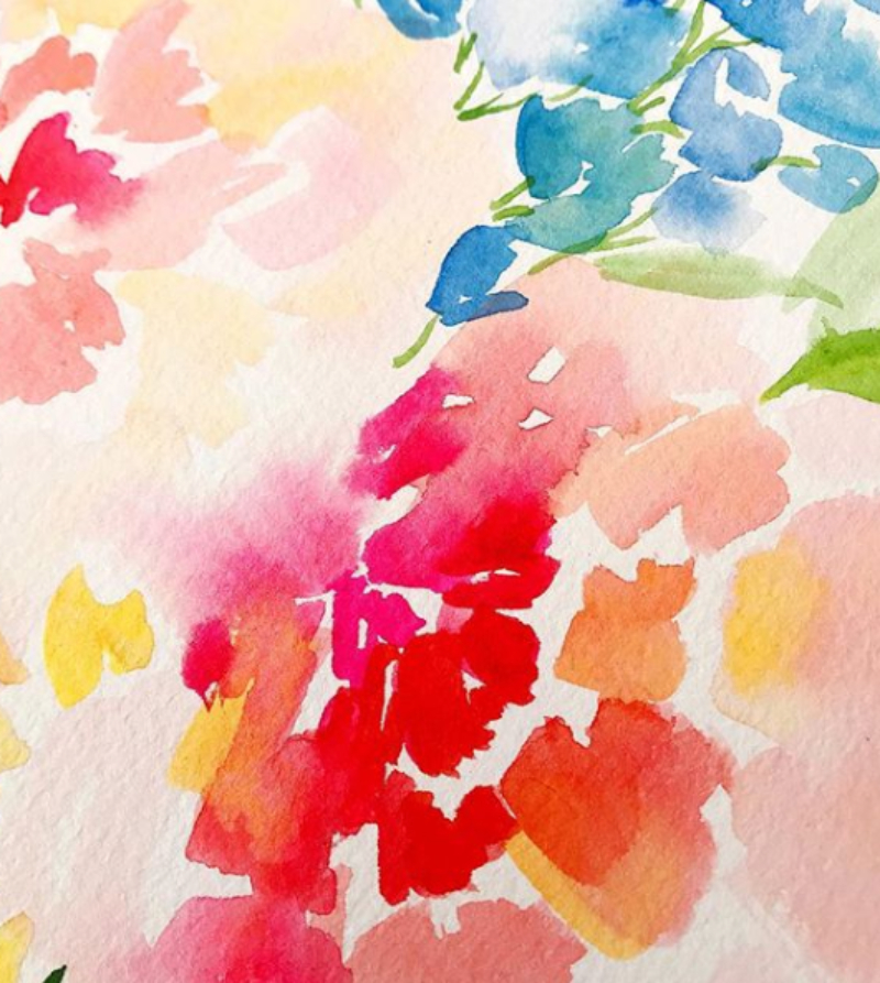 Close-up of loose watercolor florals in bright pink, blue, yellow, and peach tones on textured paper.